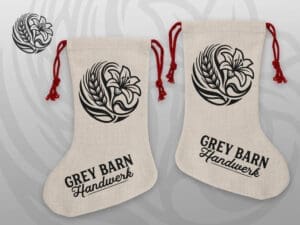 Handmade poly-linen Christmas stocking with Grey Barn Handwerk logo and red rope hanger